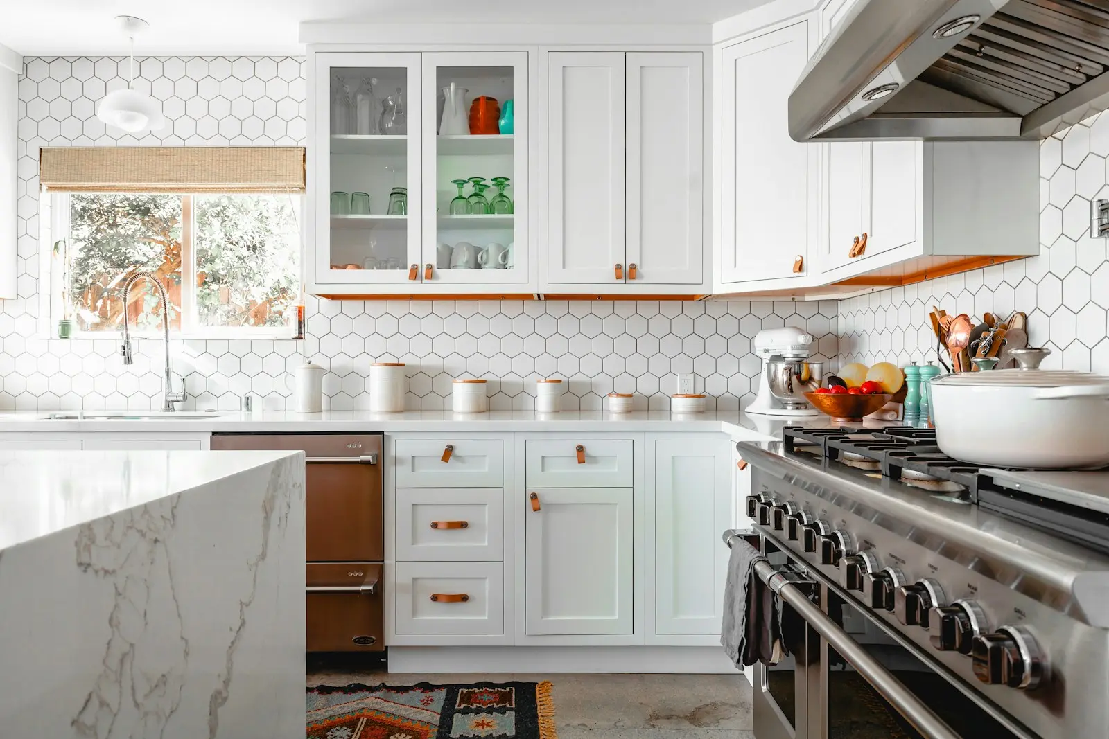 Remodeled kitchen with white cabinetry and a professional cooking range
